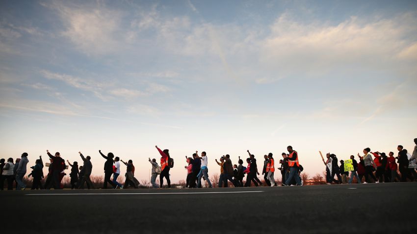 FERGUSON, MO - NOVEMBER 29:  Members of the NAACP and their supporters start out for the first day of Journey for Justice, seven-day 120-mile march from the Canfield Green apartments where Michael Brown was killed to the Governor's mansion in Jefferson City, Missouri on November 29, 2014 in Ferguson, Missouri. The Ferguson area has been struggling to return to normal since the August 9 shooting of Brown, an 18-year-old black man, who was killed by Darren Wilson, a white Ferguson police officer. When the grand jury announced on November 24, that Wilson would not face charges in the shooting rioting and looting broke out throughout the area leaving several businesses burned to the ground.  (Photo by Scott Olson/Getty Images)