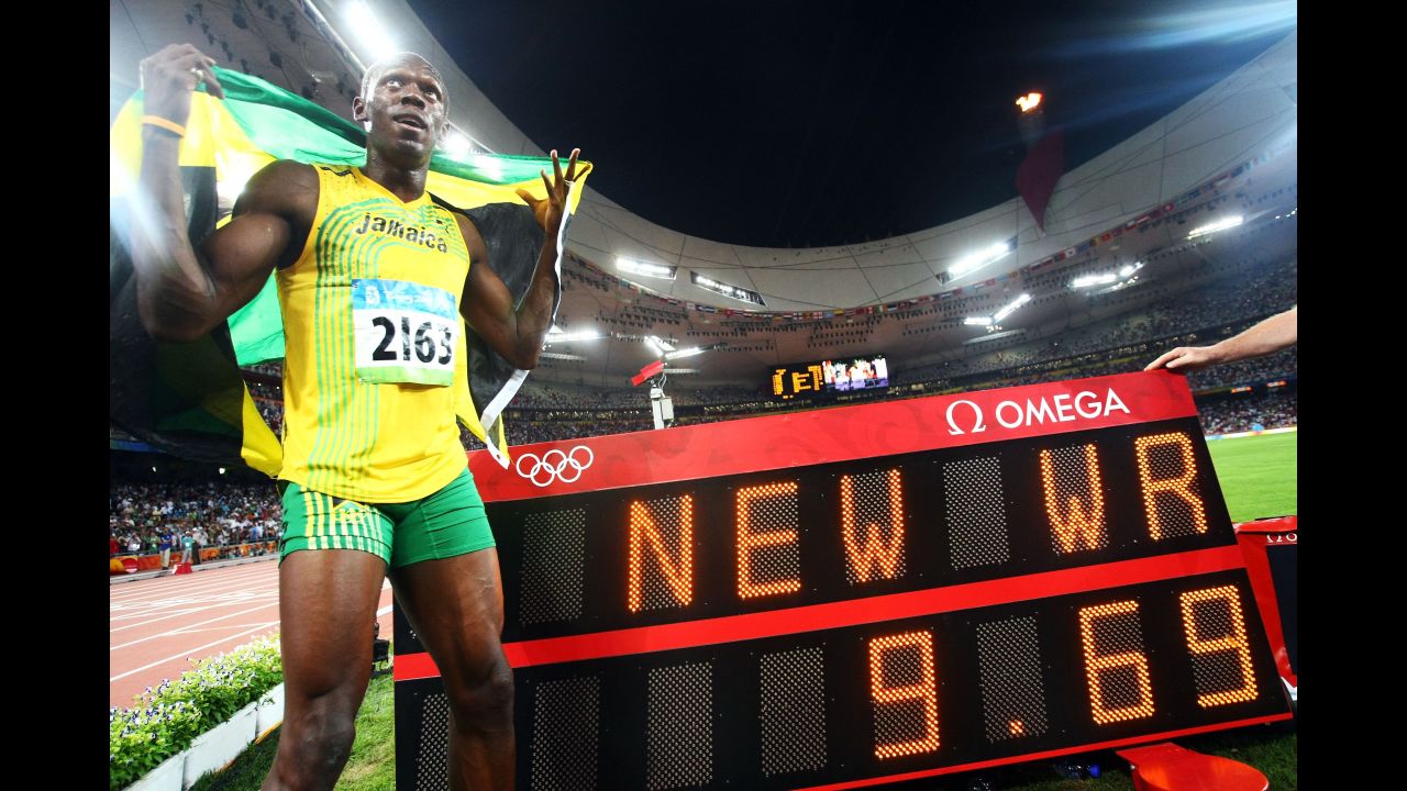Bolt celebrates next to the scoreboard after winning the men's 100-meter in Beijing.