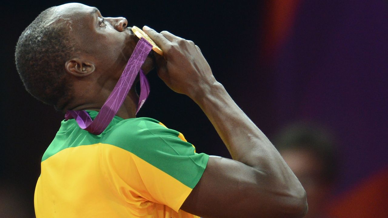 Bolt kisses his gold medal in 2012 after defending his Olympic title in the men's 200-meter. He also won the 100 again.