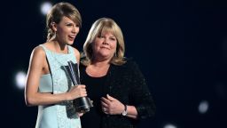 ARLINGTON, TX - APRIL 19:  Honoree Taylor Swift (L) accepts the Milestone Award from Andrea Swift onstage during the 50th Academy Of Country Music Awards at AT&T Stadium on April 19, 2015 in Arlington, Texas.  (Photo by Cooper Neill/Getty Images for dcp)