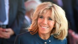 Brigitte Macron (C), wife of French President, smiles ahead of the start of the annual Bastille Day military parade on the Champs-Elysees avenue in Paris on July 14, 2017.  / AFP PHOTO / ALAIN JOCARD        (Photo credit should read ALAIN JOCARD/AFP/Getty Images)