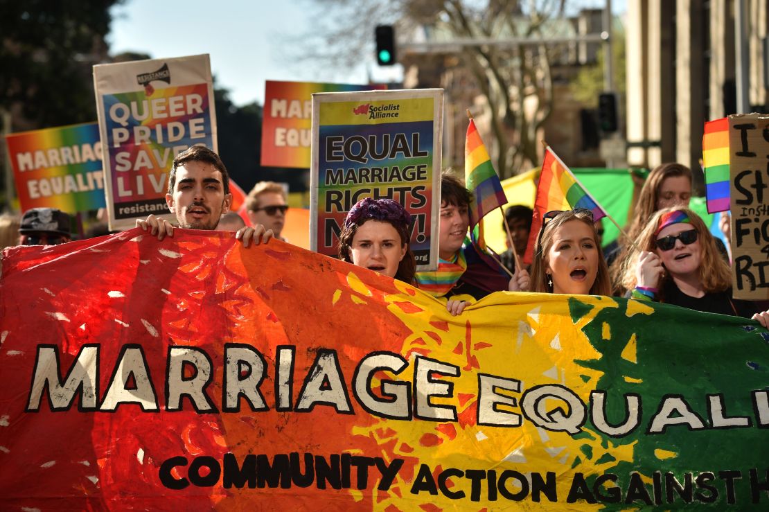 Supporters of same-sex marriage carry banners and shout slogans as they march in Sydney on August 6.