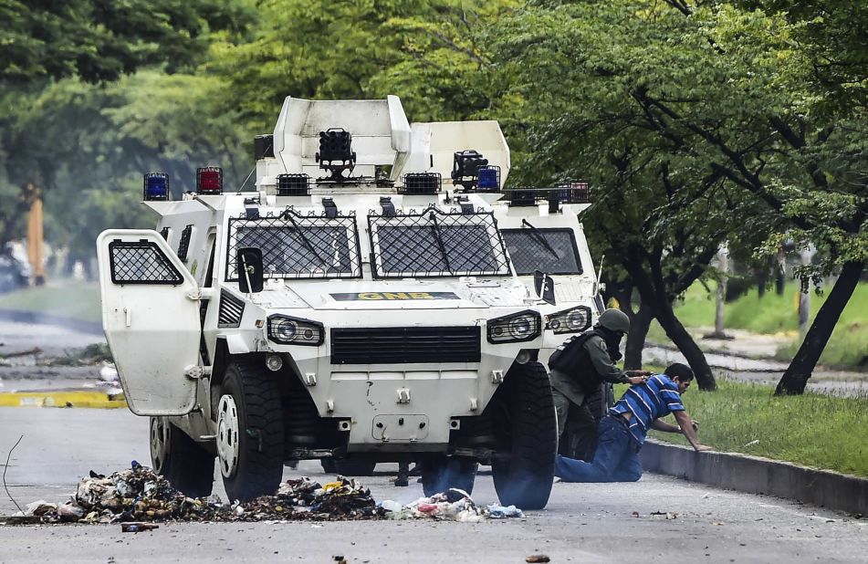 A man is arrested in Valencia during clashes between anti-government activists and the National Guard on August 6.