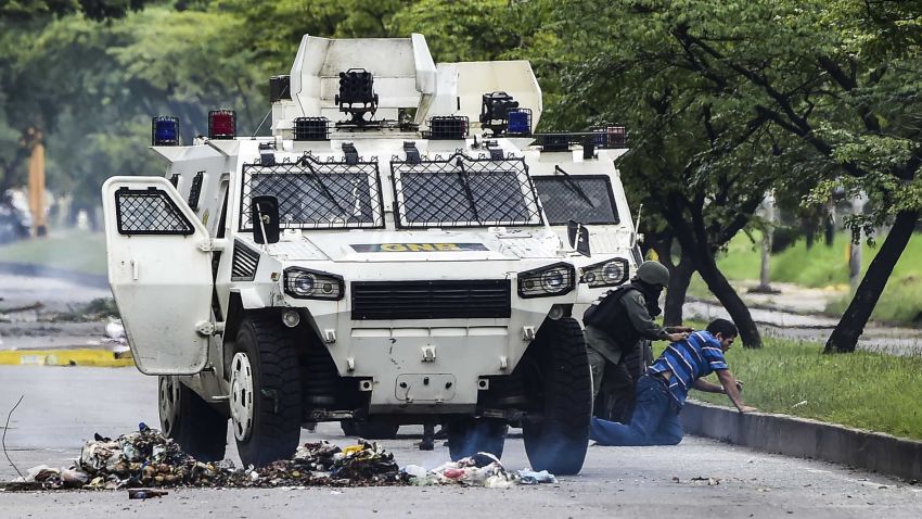 A man is arrested during clashes between anti-government activists and the National Guard in Venezuela's third city, Valencia, on August 6, 2016, a day after a new assembly with supreme powers and loyal to President Nicolas Maduro started functioning in the country.In the video posted online earlier, allegedly at an army base used by the National Bolivarian Armed Forces in Valencia, a man presenting himself as an army captain declared a "legitimate rebellion... to reject the murderous tyranny of Nicolas Maduro" and demanded a transitional government and "free elections." After the video surfaced, military chiefs said troops had put down the "terrorist" attack. / AFP PHOTO / Ronaldo SCHEMIDT        (Photo credit should read RONALDO SCHEMIDT/AFP/Getty Images)