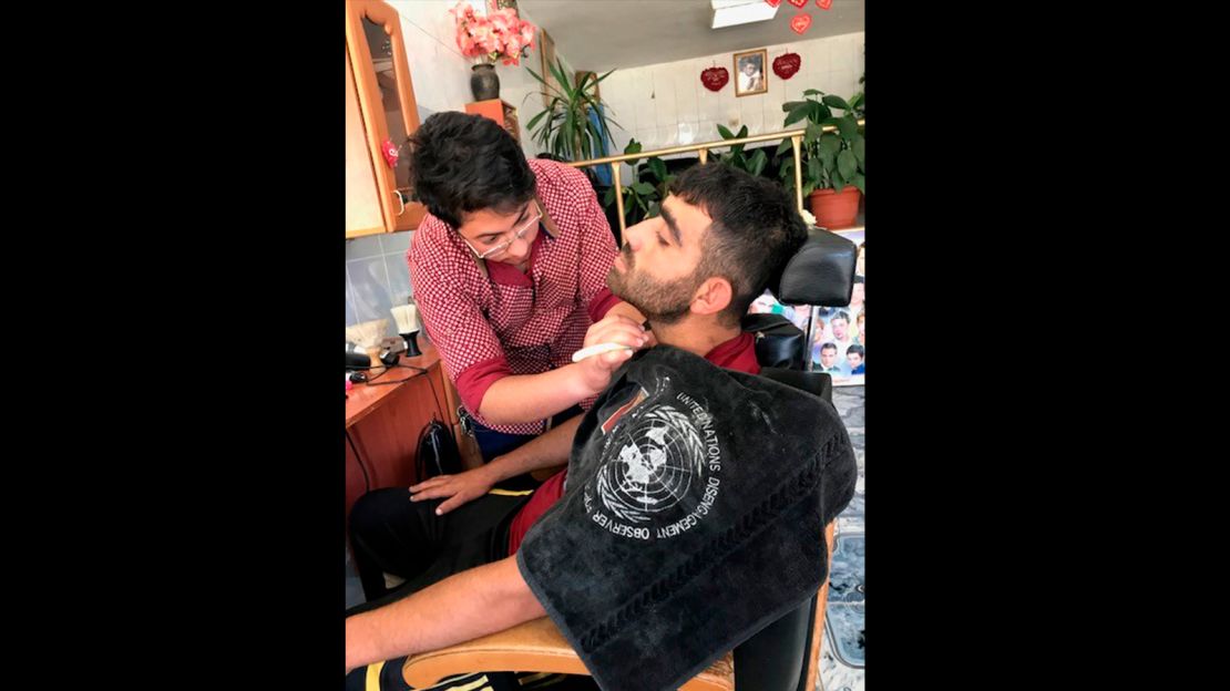 Barber Hadi al Asaad has more customers now. He hopes things will return to the way they were before the crisis with the ceasefire. 