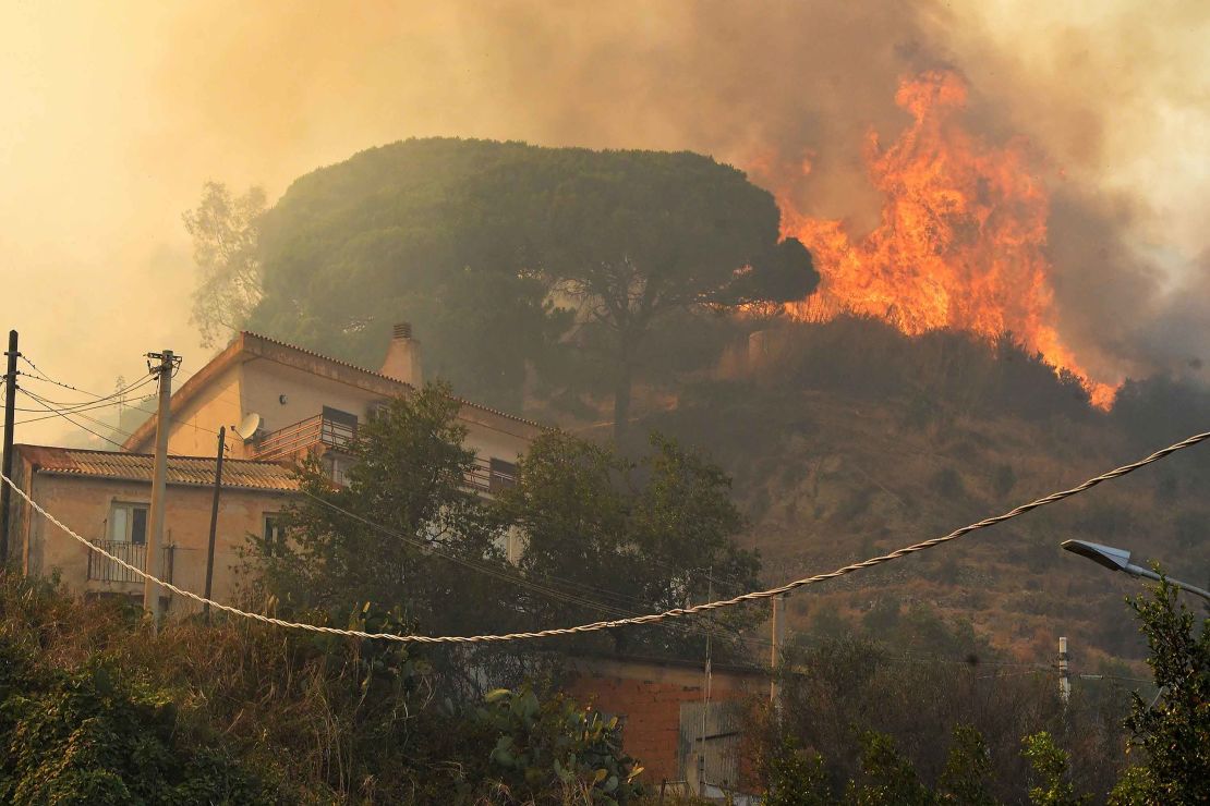A blaze rises above a community in Sicily.