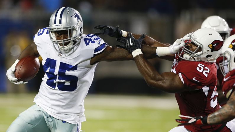 Dallas running back Rod Smith stiff-arms Arizona linebacker Zaviar Gooden during an NFL exhibition game on Thursday, August 3. It was the annual Hall of Fame Game that opens the league's preseason schedule.