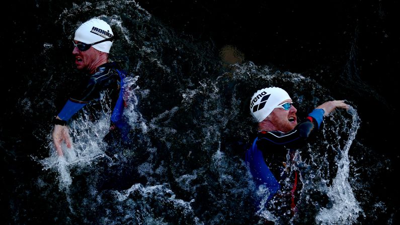 Triathletes swim during an Ironman race in Maastricht, Netherlands, on Sunday, August 6.