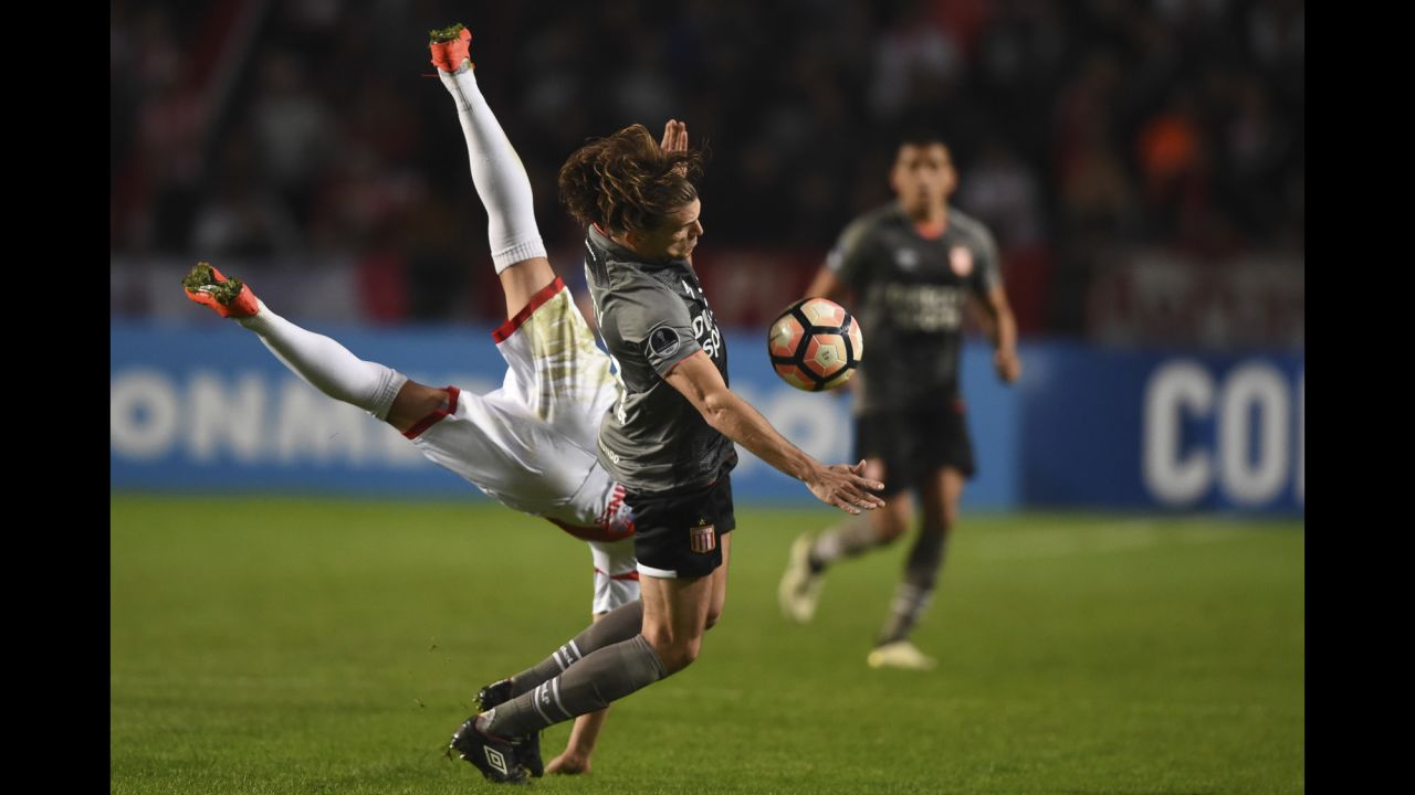 Luis Anibal Torrico, left, collides with Sebastian Dubarbier during a Copa Sudamericana match in La Plata, Argentina, on Thursday, August 3. Dubarbier and his Argentine club, Estudiantes, defeated Bolivian club Nacional Potosi to advance to the tournament's round of 16.