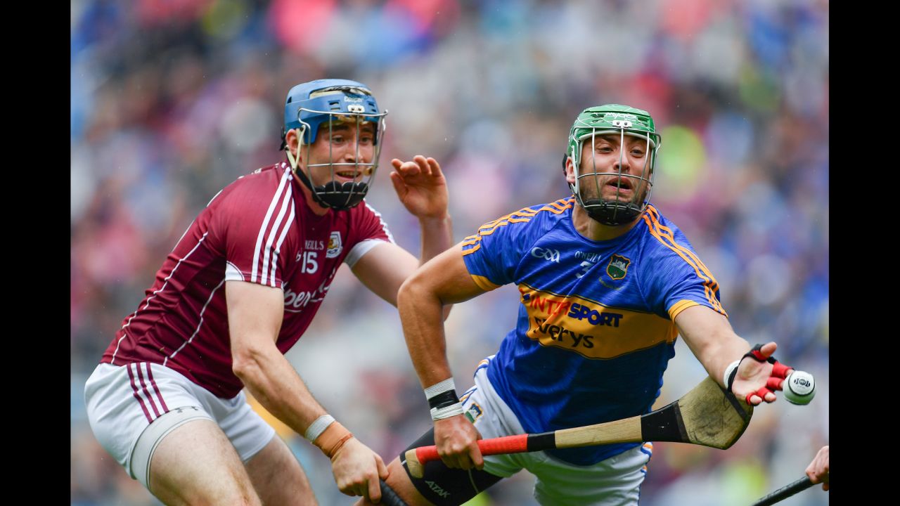 Galway's Conor Cooney, left, competes against Tipperary's James Barry during the semifinals of the All-Ireland Senior Hurling Championship. Galway advanced with a one-point victory on Sunday, August 6.