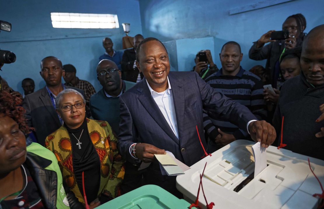 Kenyatta casts his vote alongside his wife Margaret on Tuesday. 