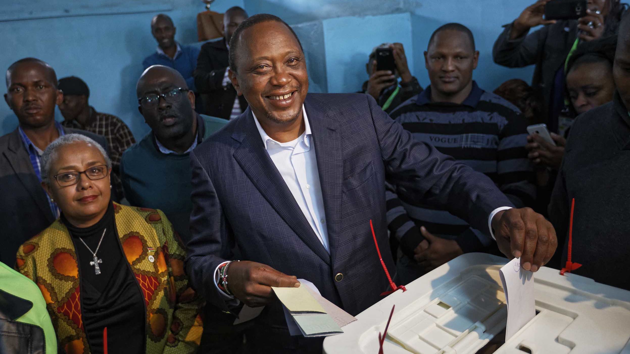 Kenyatta casts his vote alongside his wife Margaret on Tuesday. 