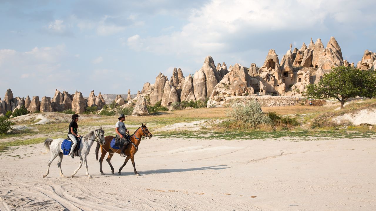 <strong>20. Ride a horse.</strong> Turkey's Cappadocia provides an otherworldly landscape ripe for exploration on horseback. <em>Photo from Shutterstock</em>
