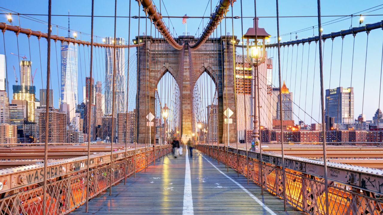 <strong>24. Walk across a famous bridge.</strong> Few bridges can match New York's Brooklyn Bridge for vibrant city views. <em>Photo from Shutterstock</em>