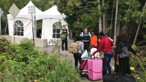 13-year-old Melissa Paul talks with Canadian officials at the border as she crosses with her mother.