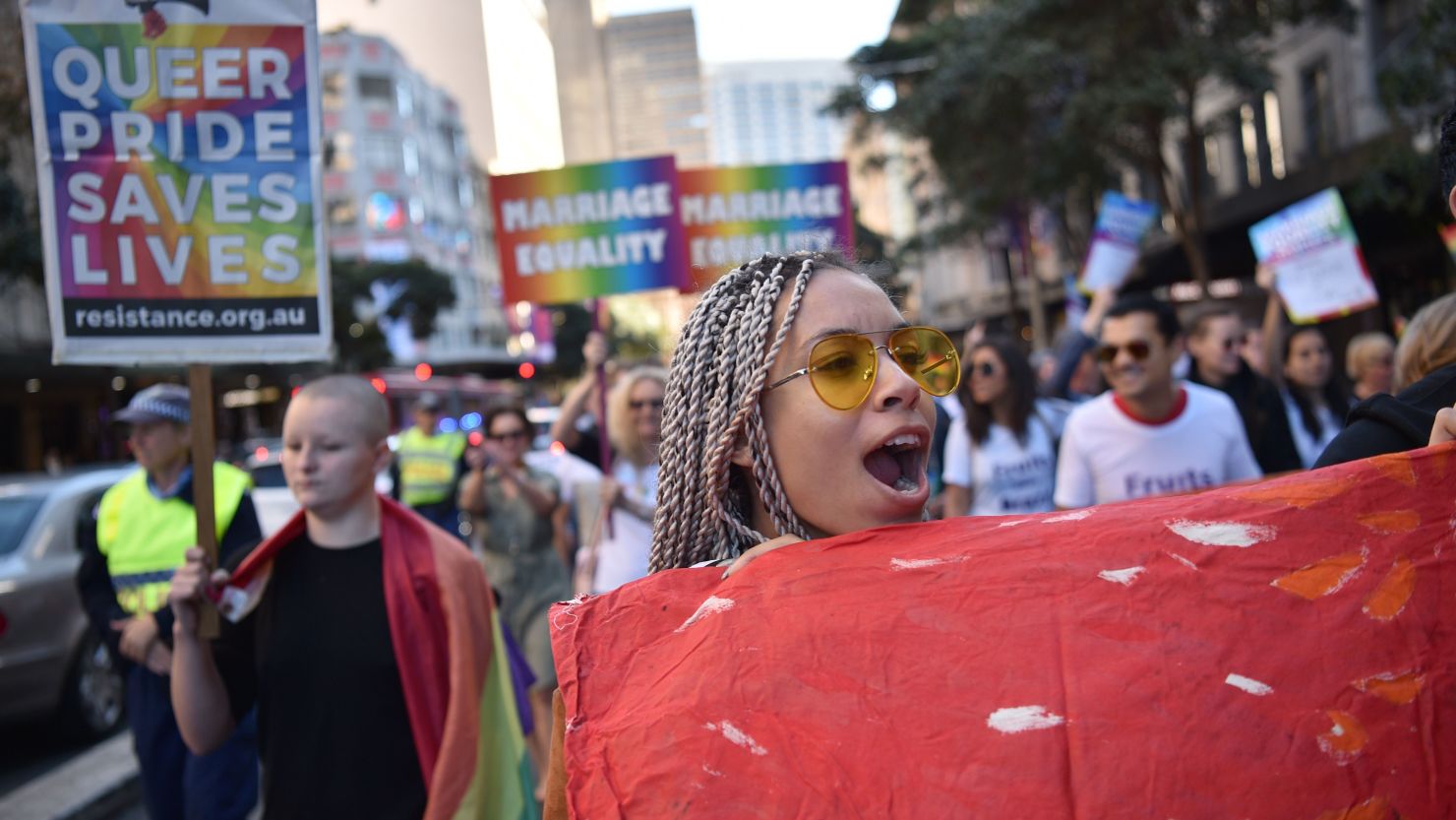 Supporters of same-sex marriage carry banners and shout slogans as they march in Sydney on August 6.