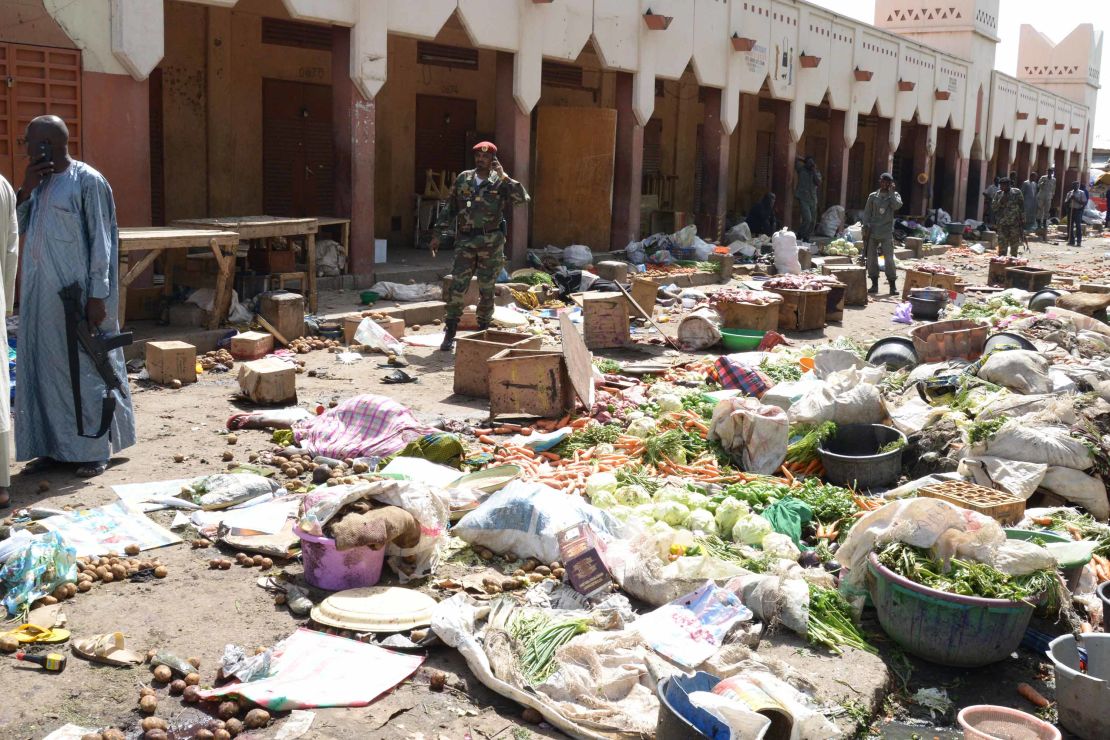 Soldiers stand guard at a market in N'Djamena, Chad, following a suicide bomb attack on July 11, 2015. At least 14 people were killed when a man dressed as a woman detonated his explosives in a crowded market in the city.