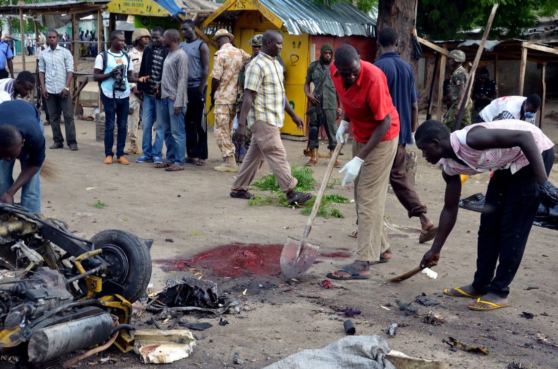 Rescuers work at the scene of a bomb attack on Gomboru market in Maiduguri, northeastern Nigeria, on July 31, 2015. A female suicide bomber who arrived on a taxi tricycle killed at least eight people.