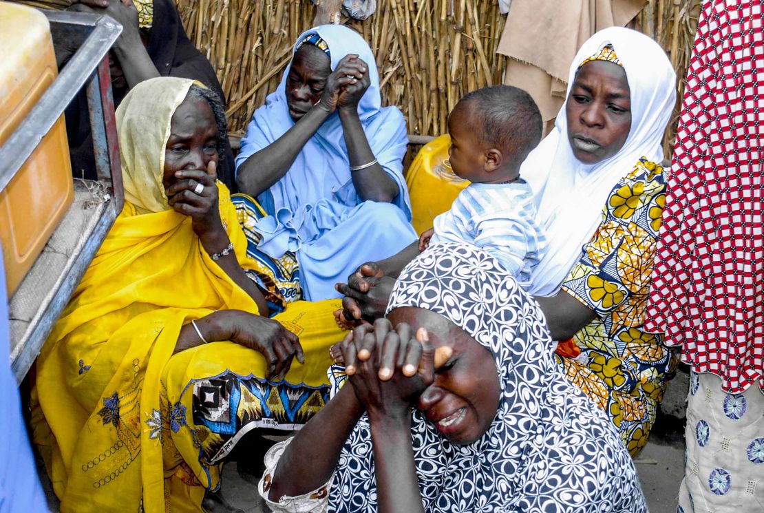 Nigerian women mourn at the site where four female suicide bombers blew themselves up near a bus station in Maiduguri, in the country's northeast, on March 15, 2017, killing two people.