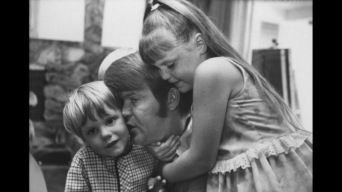 Campbell cuddles with his daughter Kelli and his son Travis in 1968. Campbell was married four times and had eight children.