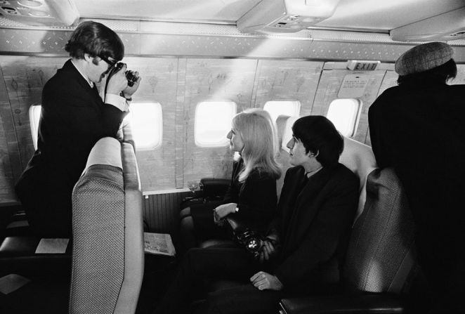 Lennon goes behind the camera to capture Harrison and Lennon's first wife, Cynthia, on route to New York in 1964. 