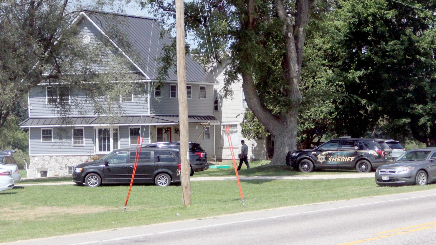 Sauk County Sheriff's Office investigators examine the scene of a fatal shooting Aug. 8 south of Loganville.