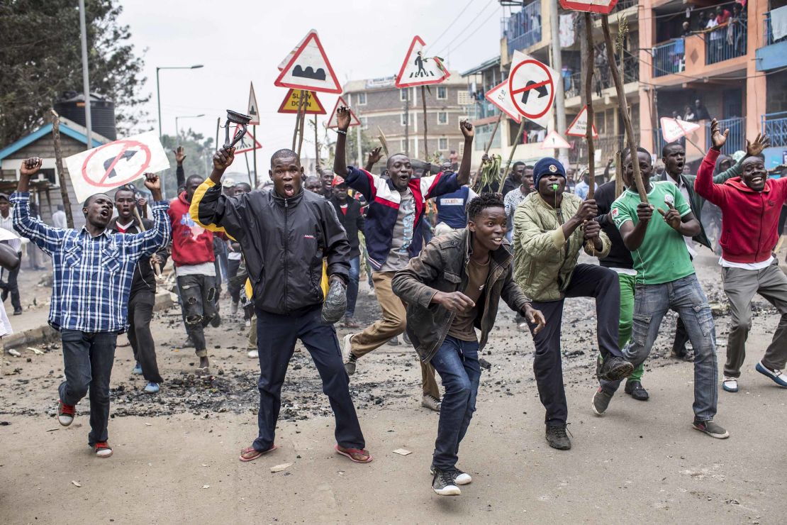 Opposition demonstrators carrying road signs shout and gesture in the Mathare slums of Nairobi on Wednesday. Odinga's hacking claims have ratched up tensions in his strongholds.