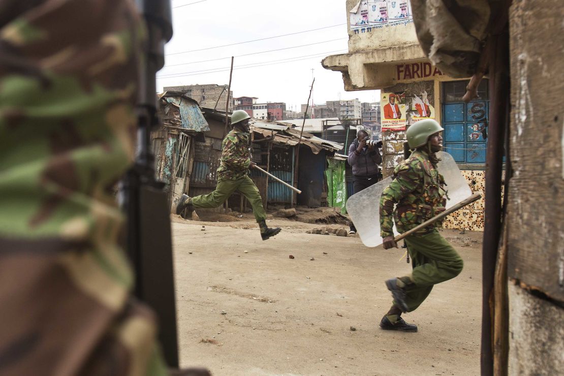 Kenyan security forces chase demonstrators in the Mathare area of Nairobi on Wednesday.