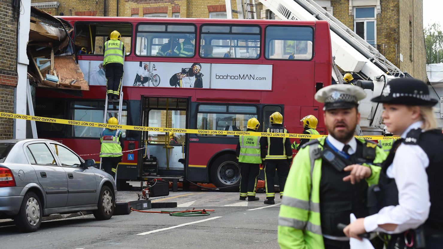 Emergency services at the scene in Lavender Hill, southwest London, after a bus left the road and hit a shop. 