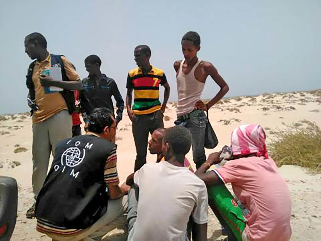 IOM staff assist migrants who were forced into the sea by smugglers on Wednesday.