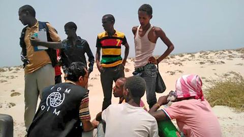 IOM staff assist migrants who were forced into the sea by smugglers on Wednesday.