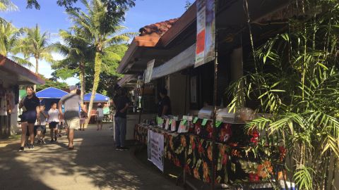 People walk through the Chamorro Village marketplace in Hagatna, Guam, Wednesday, August 9.