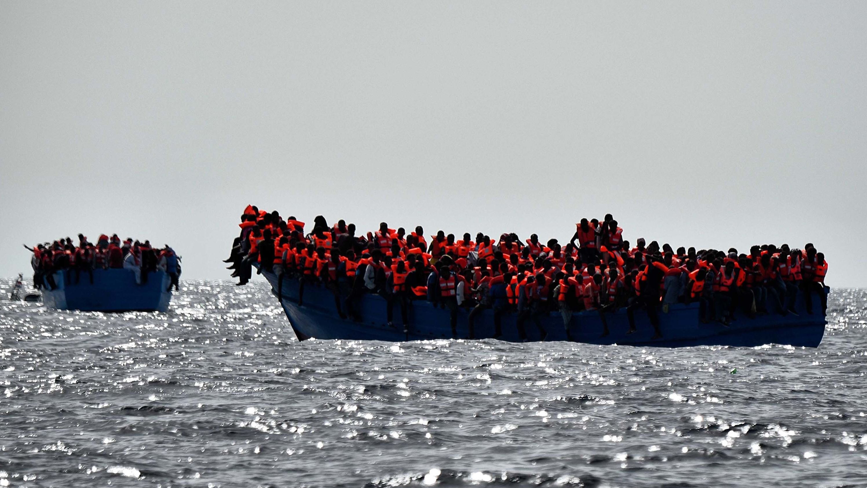 A file photo shows migrants waiting to be rescued as they drift in the Mediterranean Sea off the coast of Libya on October 3, 2016.