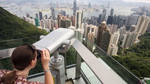 A woman looking at the view from the Peak Tower.