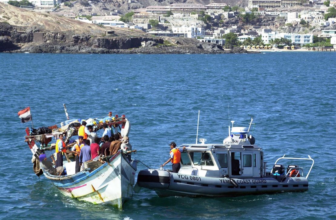 An undated photo shows Yemeni coast guards checking a boat with refugees arriving in Aden.  