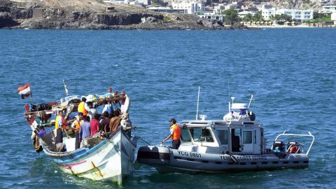 An undated photo shows Yemeni coast guards checking a boat with refugees arriving in Aden.  