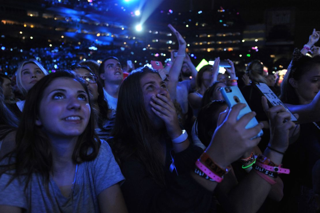 Fans react to Taylor Swift as she performs on her "The 1989 World Tour" at Raymond James Stadium on October 31, 2015 in Tampa, Florida.