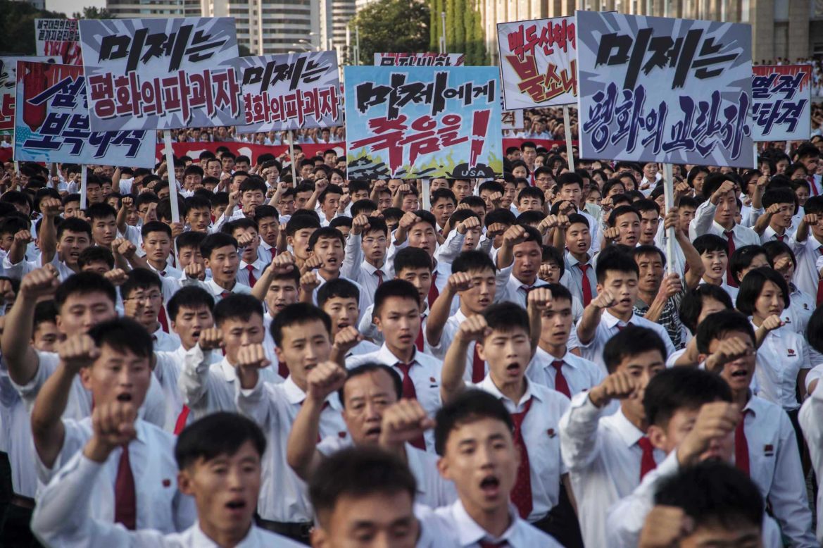 People carry signs and thrust their fists in the air during the rally. The United Nations Security Council <a href="http://www.cnn.com/2017/08/05/asia/north-korea-un-sanctions/index.html" target="_blank">recently imposed new sanctions on North Korea</a> for its continued tests of intercontinental ballistic missiles.