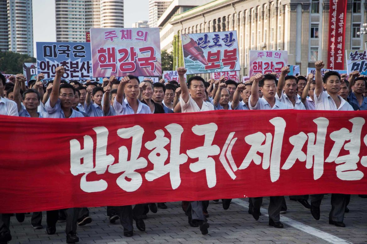 Demonstrators carry a banner and shout slogans during the rally. <a href="http://www.cnn.com/2017/08/09/politics/north-korea-considering-near-guam-strike/index.html" target="_blank">A North Korean plan</a> to fire four missiles near the US Pacific territory of Guam will be ready for Kim Jong Un's consideration in days, state media has reported, as <a href="http://www.cnn.com/2017/08/10/politics/trump-north-korea-threat/index.html" target="_blank">an unprecedented exchange of military threats</a> between Washington and Pyongyang intensifies.