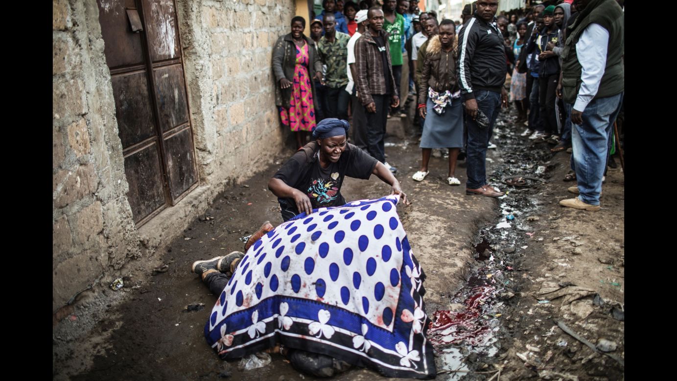 A woman uses a blanket to cover the body of her dead son Wednesday, August 9, in the slum area of Mathare, which is on the outskirts of Nairobi, Kenya. In the aftermath of the country's presidential election, <a href="http://www.cnn.com/2017/08/09/africa/kenya-election/index.html" target="_blank">confrontations were reported</a> between police and protesters. Two protesters were shot in Mathare, said two sources who aren't being named for their safety.