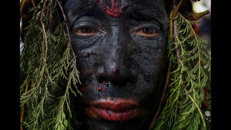 A man with a painted face takes part in the Gai Jatra (Cow Festival) in Kathmandu, Nepal, on Tuesday, August 8. Hindus celebrate Gai Jatra to ask for salvation and peace for their family members who have passed away. Cows are regarded as holy animals in Nepal, and according to belief they help departed souls reach heaven.