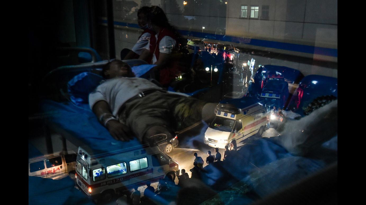 An earthquake survivor, lying on a hospital bed, is reflected in a window as ambulances line up outside the hospital in Jiuzhaigou, China, on Wednesday, August 9. <a href="http://www.cnn.com/2017/08/08/asia/china-earthquake/index.html" target="_blank">A powerful earthquake</a> struck the popular tourist area in southwest China.