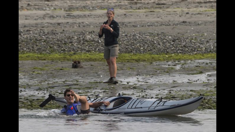 Canadian Prime Minister Justin Trudeau falls into the water as he tries to get into a kayak near Sidney, British Columbia, on Saturday, August 5.