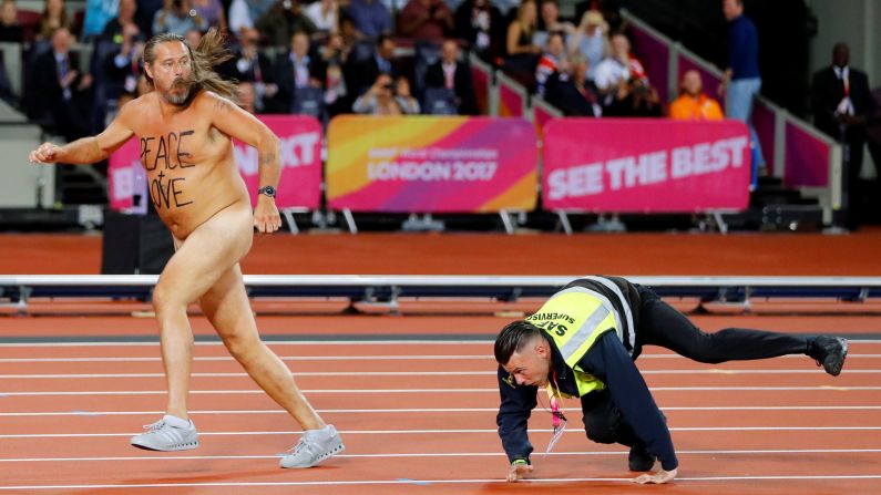A steward chases a streaker in London that ran onto the track at the World Championships on Saturday, August 5.