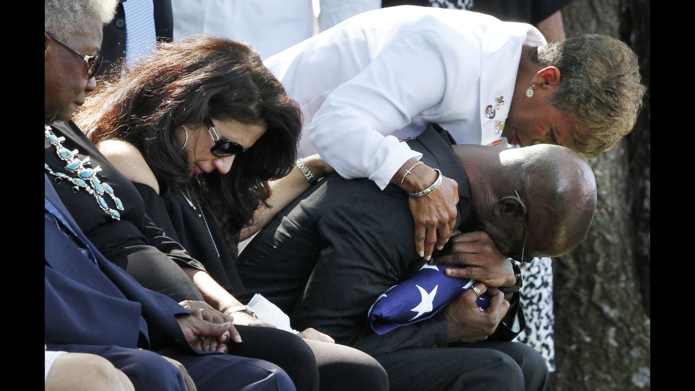 Darrold Martin is comforted by Janice Chance during the burial service for his son, Navy Petty Officer 1st Class Xavier Alec Martin, on Wednesday, August 9. The 24-year-old sailor from Halethorpe, Maryland, was <a href="http://www.cnn.com/2017/06/19/politics/sailor-profiles-uss-fitzgerald/index.html" target="_blank">one of seven sailors killed in June </a>when the USS Fitzgerald collided with a container ship off the coast of Japan.