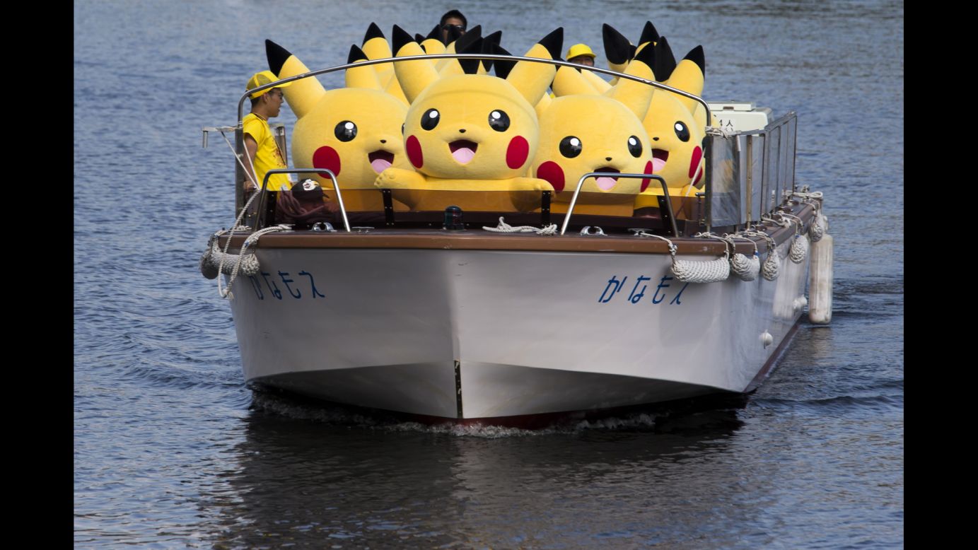Performers dressed as Pikachu, a character from the "Pokemon" franchise, ride on a boat during the Pikachu Outbreak event in Yokohama, Japan, on Wednesday, August 9. Hundreds of Pikachus are appearing at city landmarks to attract visitors and tourists through August 15.