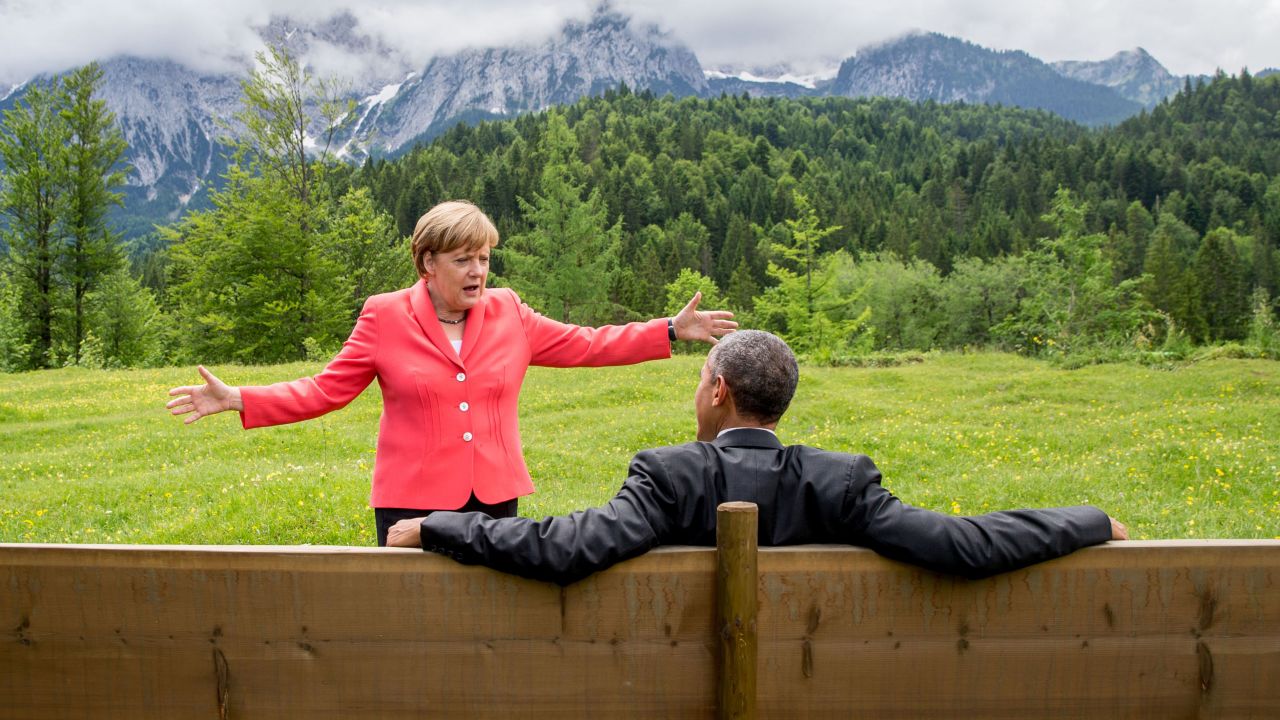 Germany's Chancellor Angela Merkel (L) gestures while chatting with US President  Barack Obama sitting on a bench outside the Elmau Castle after a working session of a G7 summit near Garmisch-Partenkirchen, southern Germany, on June 8, 2015. AFP PHOTO / POOL / MICHAEL KAPPELER / AFP / POOL / MICHAEL KAPPELER        (Photo credit should read MICHAEL KAPPELER/AFP/Getty Images)