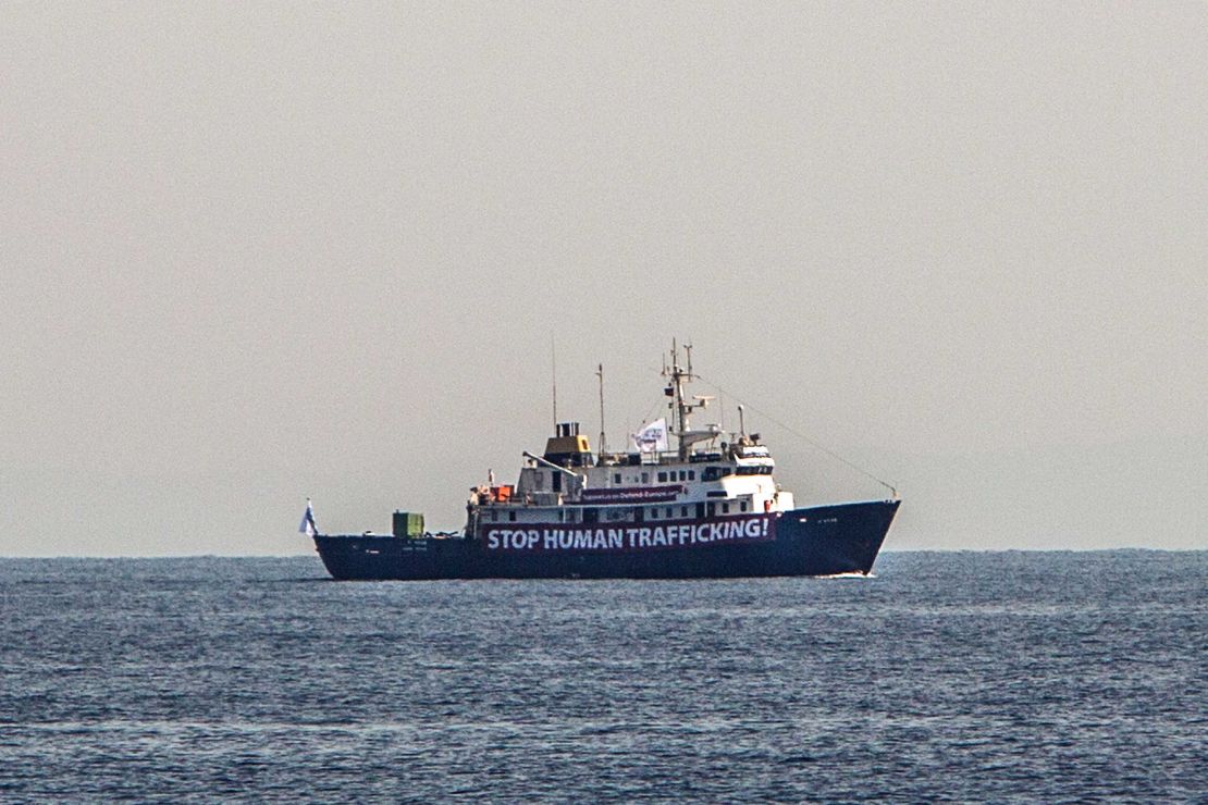 A banner that reads 'Stop Human Trafficking' is attached to the side of the C-Star as it sails in the Mediterranean Sea.