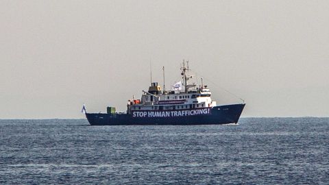 A banner that reads 'Stop Human Trafficking' is attached to the side of the C-Star as it sails in the Mediterranean Sea.