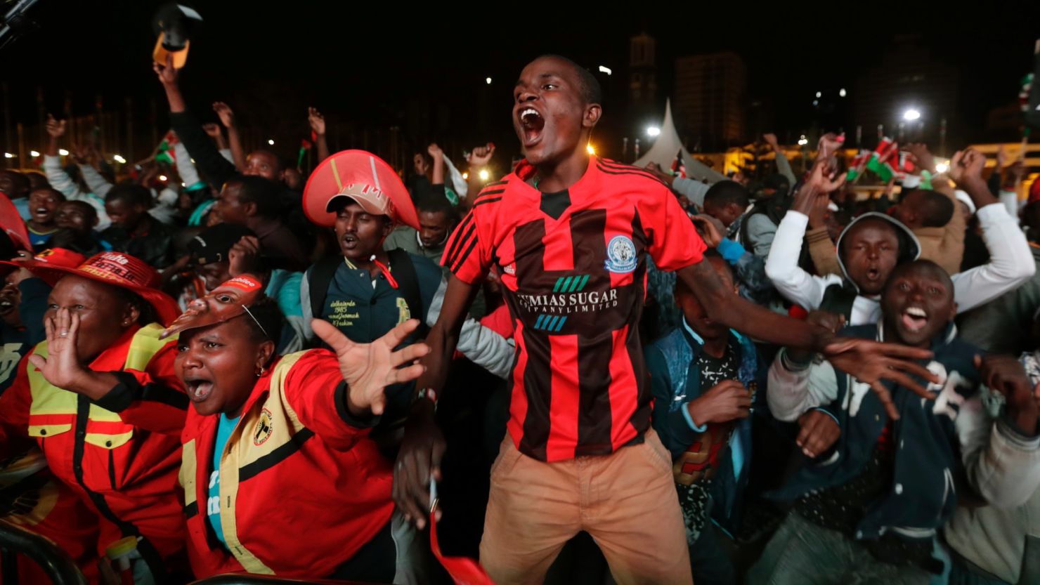 Supporters of Kenya's President Uhuru Kenyatta cheer as they hear the election results.